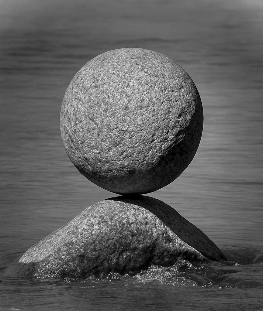 Round stone balanced on a smaller stone.