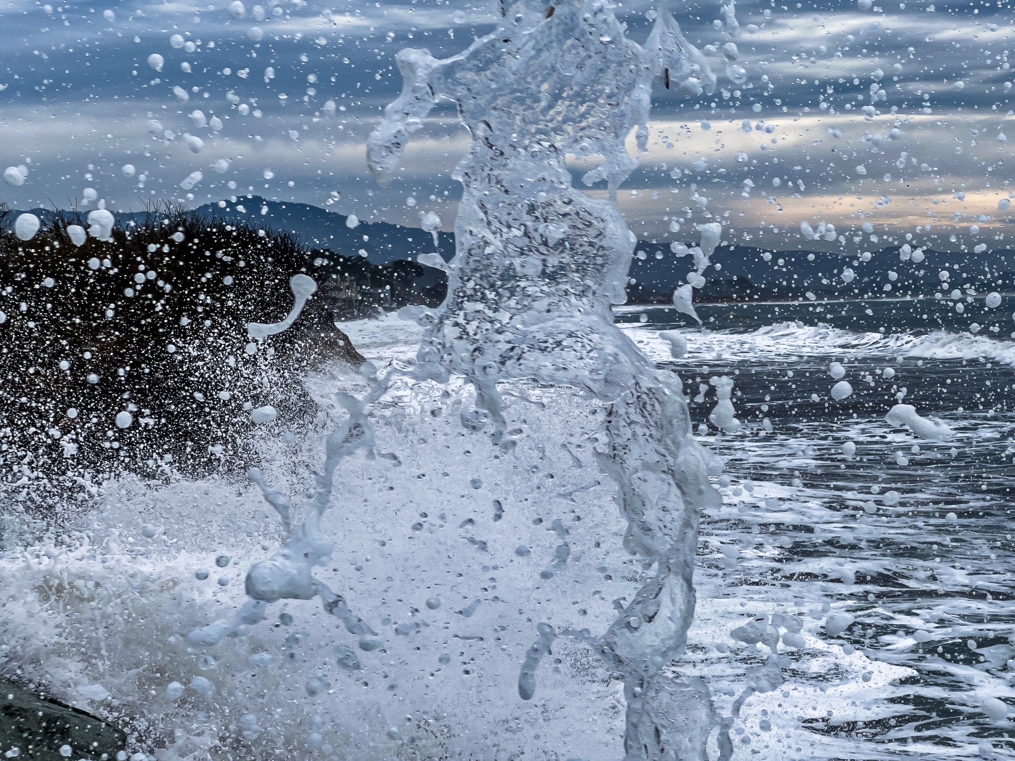 Ocean wave crashing against a seawall